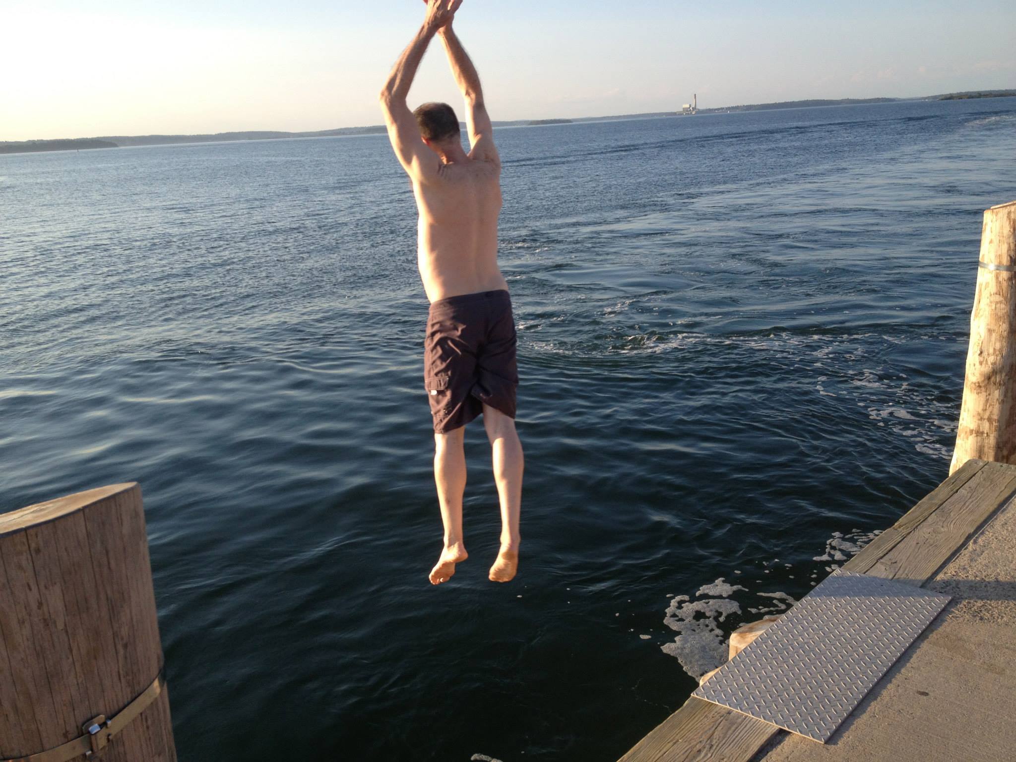 Bruce Ballard jumping off the dock on Long Island, Maine