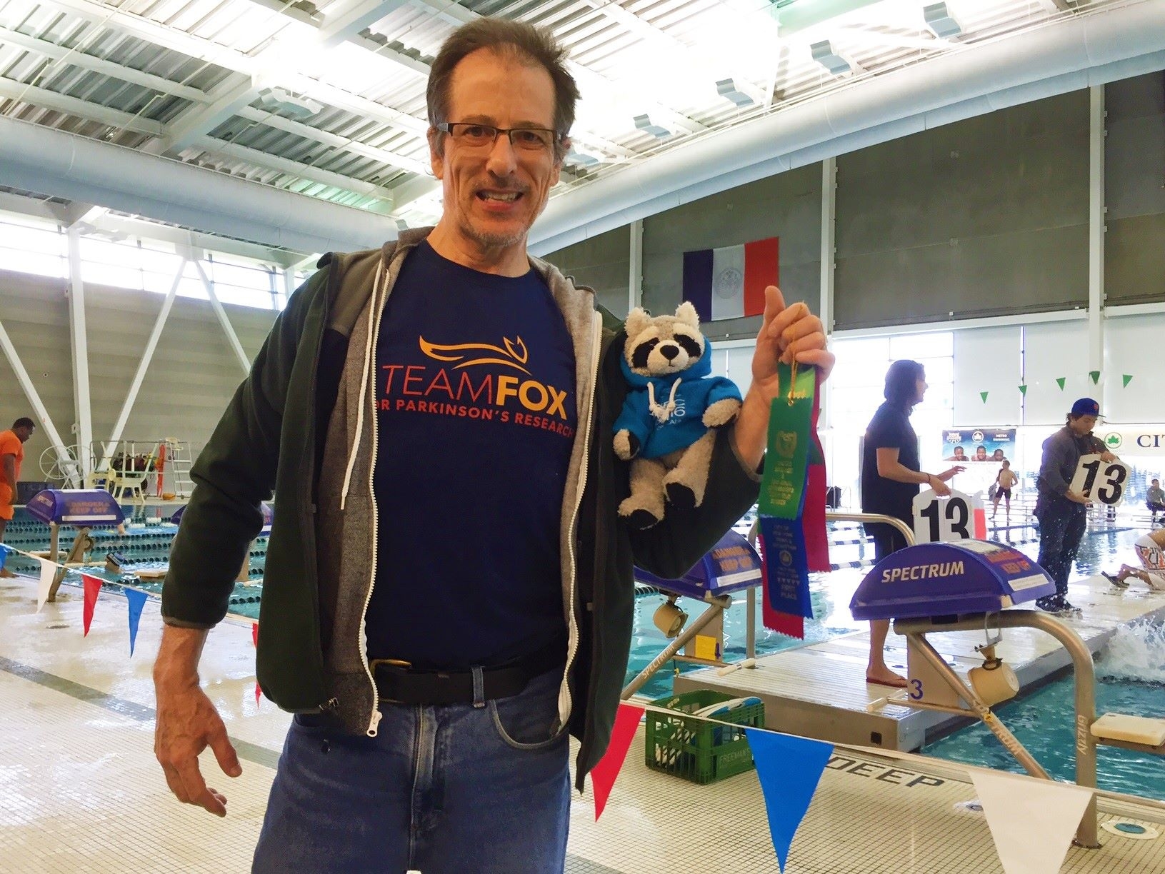 Bruce Ballard participating a swim meet In New York City with Parky the Raccoon